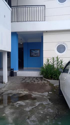 a white car parked in front of a building at Hotel Arda Bali in Negara
