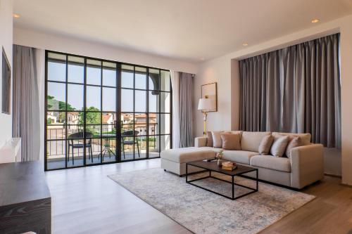 a living room with a couch and a table at Estella Khao Yai in Khao Yai