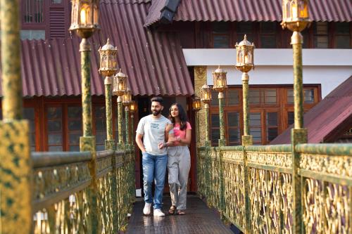 a man and a woman standing on a bridge at Koviloor Resort in Vattavada