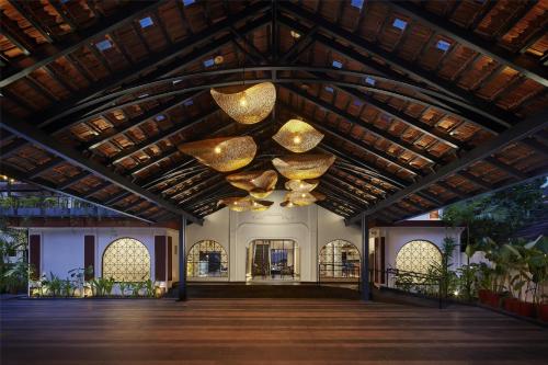 a large building with a large ceiling with gold chandeliers at Hyatt Ronil Goa - a JdV by Hyatt Hotel in Calangute