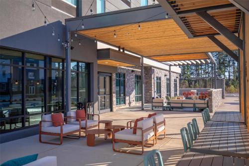 an outdoor patio with a table and chairs at Home2 Suites By Hilton Smithfield Selma in Smithfield