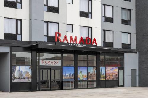 a store front of a building with a sign on it at Ramada by Wyndham Brooklyn Near Flatbush in Brooklyn