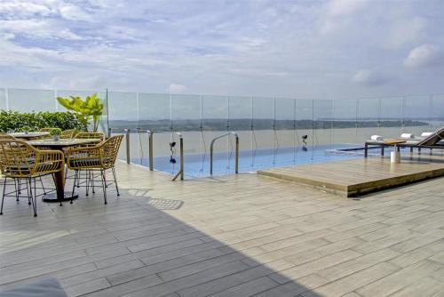 a patio with a table and chairs and a pool at DoubleTree by Hilton Guayaquil in Guayaquil