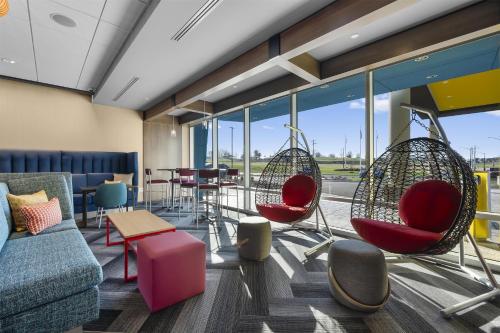 a lobby with chairs and a couch and a table at Tru By Hilton Cape Girardeau in Cape Girardeau