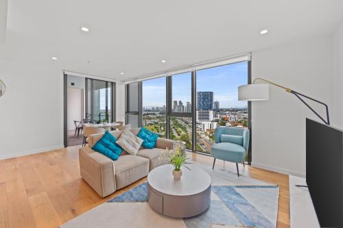 a living room with a view of a city at Marine Quarter Apartments by CLLIX in Gold Coast
