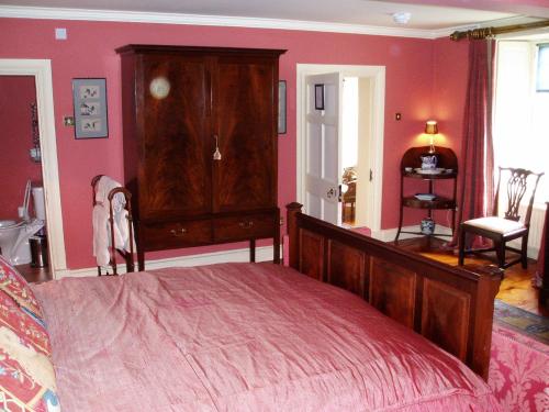 a bedroom with a bed and a dresser in it at Collon House in Collon