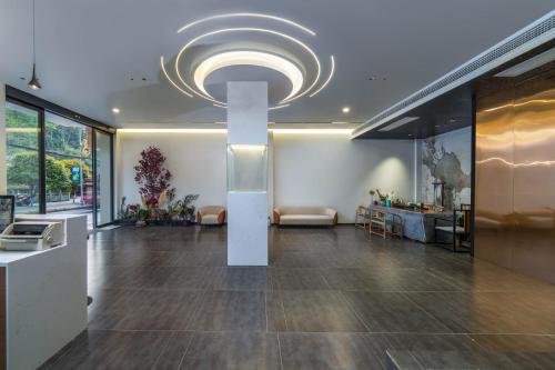 a large lobby with a large chandelier in a building at Phoenix Mandu River View Homestay in Fenghuang