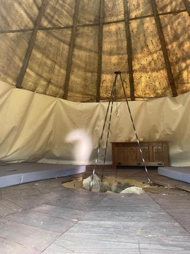 a tripod in a tent with a camera in it at Fox House Tisá / Rájec in Tisá