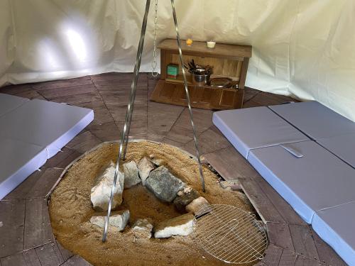 an inside of a yurt with a dead animal in a pit at Fox House Tisá / Rájec in Tisá