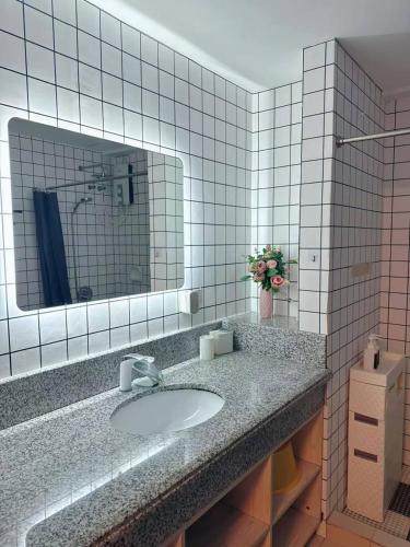 a bathroom with a sink and a mirror at Torre De Manila in Manila