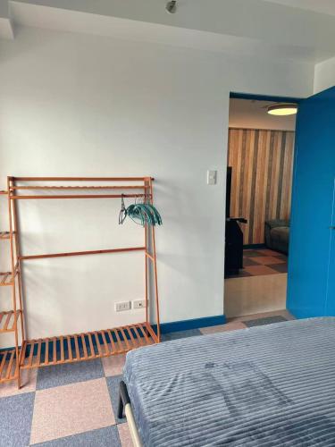 a room with a bed and a blue wall at Torre De Manila in Manila