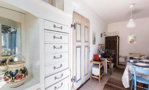 a room with a white dresser and a desk at HouseLake and Garden - Pescate - Lecco in Galbiate