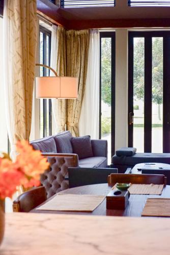 a living room with a couch and a table at Bonheur at Karambunai in Kota Kinabalu