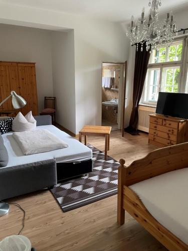 a bedroom with two beds and a chandelier at Gästehaus Hohe Tannen in Garmisch-Partenkirchen