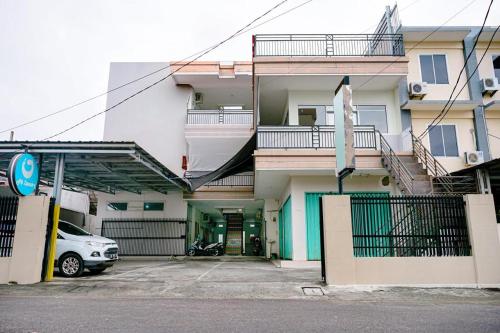 a white car parked in front of a building at Griya Safitri Syariah in Palembang