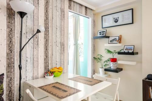 a dining room with a white table and a window at White Bear 1663 Zemun Oldest House Apartment in Zemun