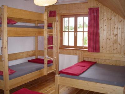 a room with three bunk beds in a cabin at Neue Gehlberger Hütte in Suhl