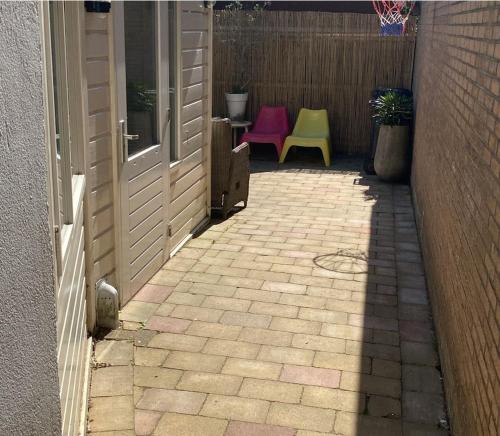 an entrance to a patio with a door and a bench at Spes Salutis in Badhoevedorp