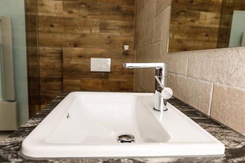 a white sink in a bathroom with a mirror at Apartment Hüttegg in Weerberg
