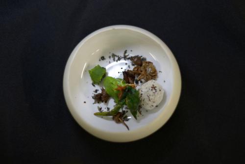 a white plate with some food on a table at Logis Hotel Restaurant Au Boeuf Rouge in Niederschaeffolsheim