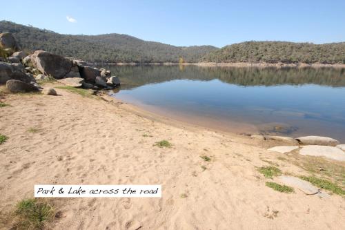 a beach with the words park like across the road at Full Circle Apartments in Jindabyne