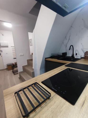 a kitchen with a counter with a sink and a counter top at La Casita de Cullera in Cullera