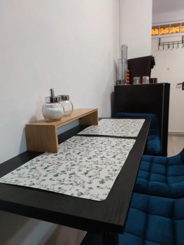 a dining room table with a blue couch and a blue chair at La Casita de Cullera in Cullera