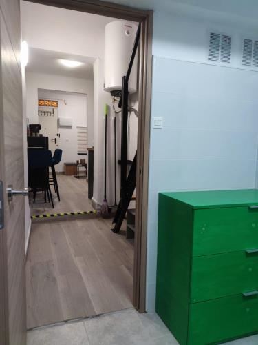 a hallway with a green cabinet and a dining room at La Casita de Cullera in Cullera