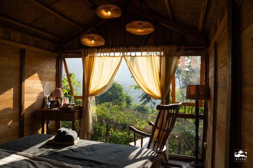 a bedroom with a bed and a large window at Xieng Retreat in Hanoi