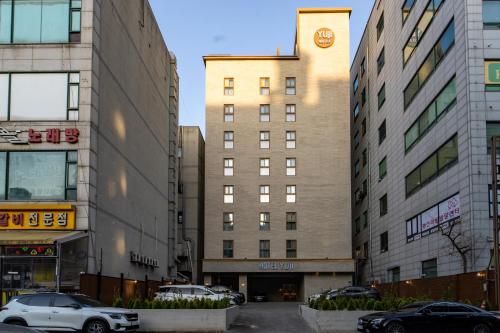 a building with a clock on the side of it at Goyang Hotel Yuji in Goyang