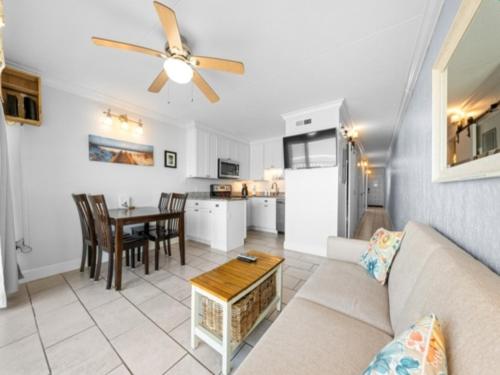 a living room with a couch and a table at Southern Comfort - Expansive views of the ocean and beach! Newly renovated plus top grade linens! condo in Carolina Beach