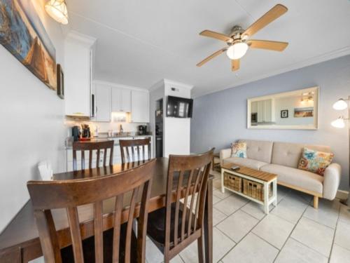 a living room and kitchen with a couch and a table at Southern Comfort - Expansive views of the ocean and beach! Newly renovated plus top grade linens! condo in Carolina Beach