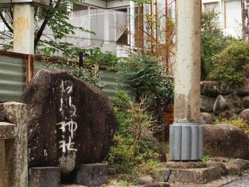 a grave with writing on it next to a pole at Shuzenji Onsen Hotel Takitei in Izu