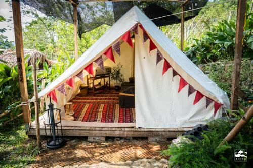 a tent with a table and chairs in it at Xieng Retreat in Hanoi