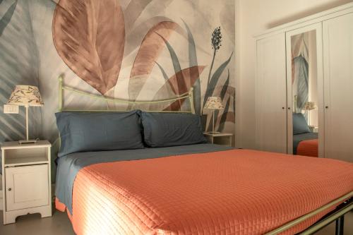 a bedroom with a bed with a large painting on the wall at Residence Valeria in Cervia