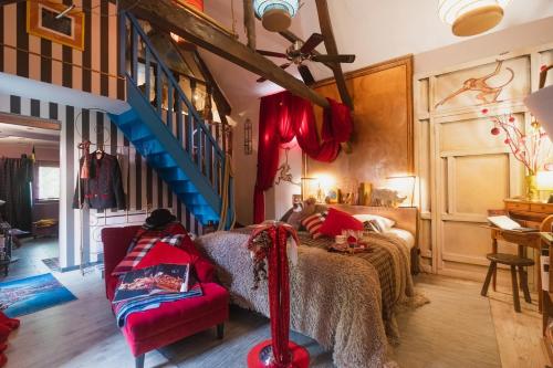 a bedroom with a bed and a blue staircase at Au2 Maison d'Hôtes - Guest House Au2 in Muidorge