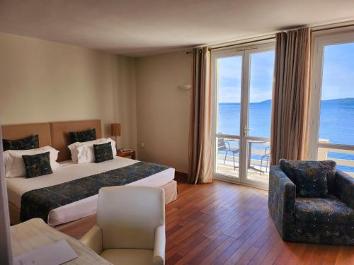 a hotel room with two beds and a view of the ocean at La Belle Aurore in Sainte-Maxime
