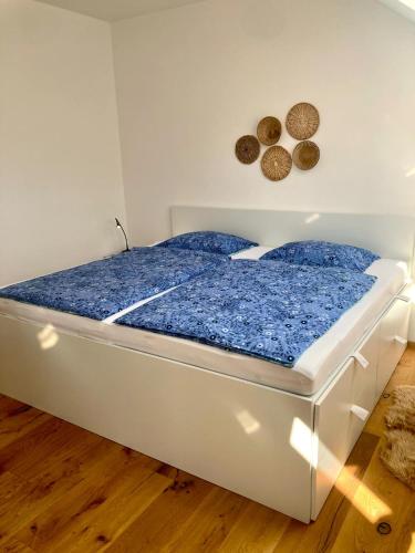 a white bed with blue sheets in a room at Sunny AP22 in Bovec