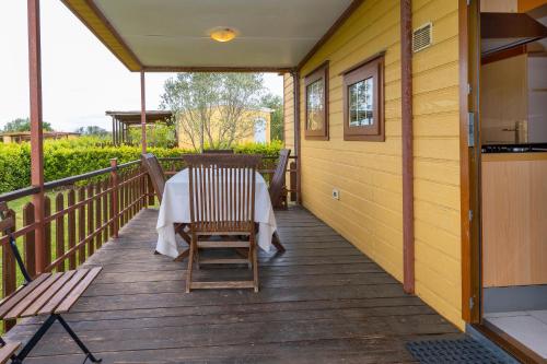 a porch with a table and chairs on it at Agriturismo Nonna Stella in Bibbona