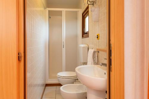a bathroom with a white toilet and a sink at Agriturismo Nonna Stella in Bibbona