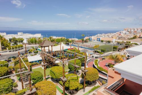 an aerial view of a park with a roller coaster at Landmar Costa los Gigantes Family Resort in Puerto de Santiago