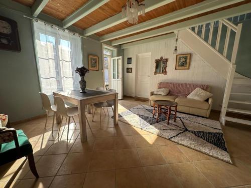 un salon avec une table et un canapé dans l'établissement Le Nid du Matelot, à Saint-Vaast-la-Hougue