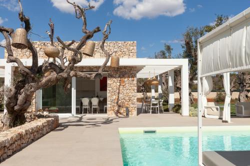 a villa with a swimming pool and a house at Villa Ghislena by salentoltremare in Marina San Gregorio