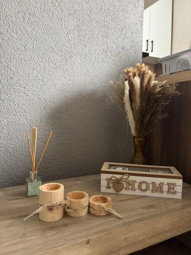 a wooden table with three coffee cups and a box at A&A Apartment in Sarajevo