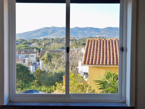an open window with a view of a city at Mbird Rosario Family House in Cascais