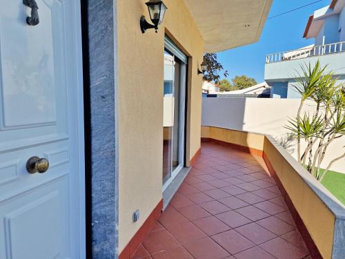 a door of a house with a tile walkway at Mbird Rosario Family House in Cascais