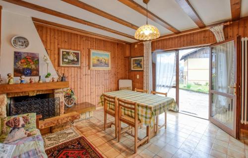 a dining room with a table and a fireplace at Casa Davide in Lamon