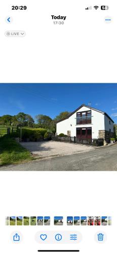 a screenshot of a website with a white building at Trelowen Cottage in Callington