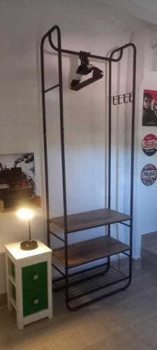 a metal shelf with a lamp next to a table at La Casita de Cullera in Cullera