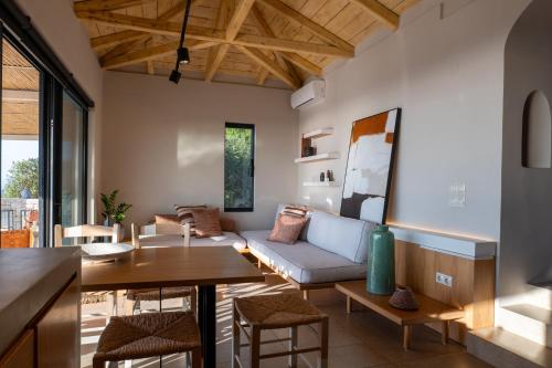 a living room with a couch and a table at Artblue Villas in Tsoukaladhes